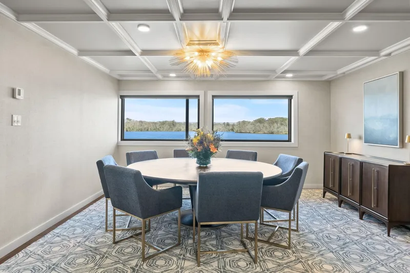 Shine Down Yacht Photos Pics Elegant dining room on Breaux Brothers 120 GLV yacht, featuring lake view and modern decor.