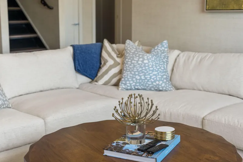 Shine Down Yacht Photos Pics ```json { "alt_text": "Modern living room with beige sectional sofa and decorative pillows." } ```