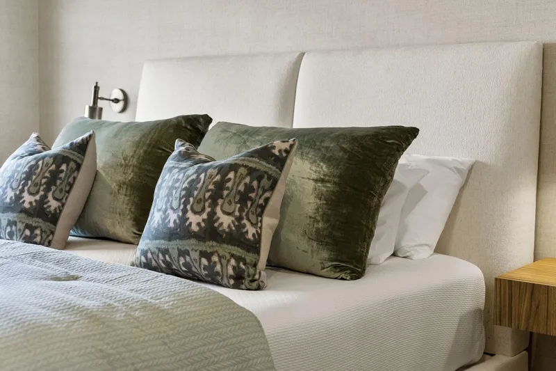 Shine Down Yacht Photos Pics Luxurious bedroom with green velvet pillows and elegant bedding, Breaux Brothers 120 GLV 2025.