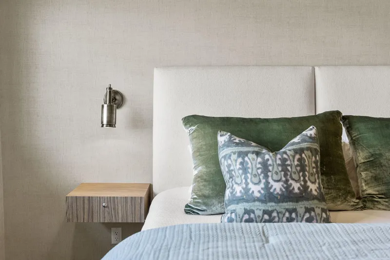 Shine Down Yacht Photos Pics Modern bedroom with green pillows, wall-mounted light, and wooden nightstand. Breaux Brothers 120 GLV 2025.