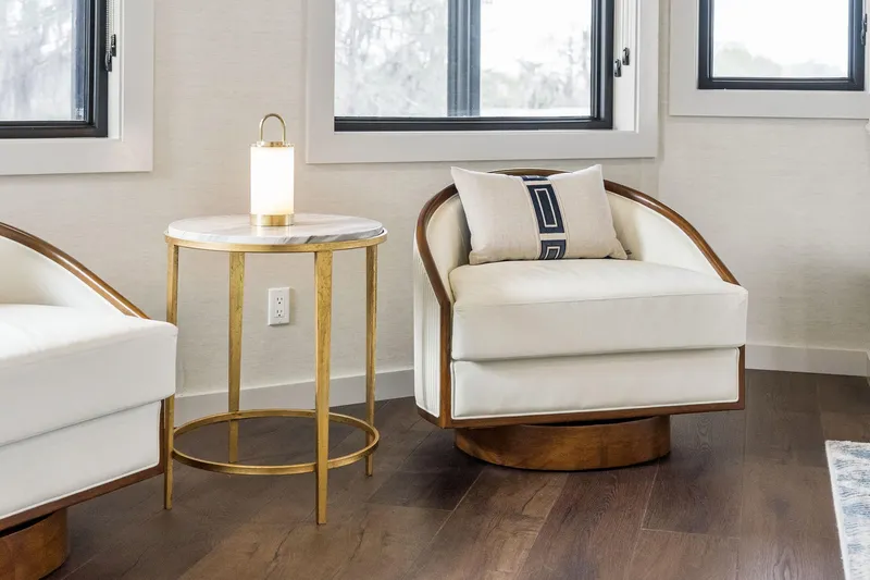 Shine Down Yacht Photos Pics Modern living room with white armchairs, gold side table, and soft lighting.