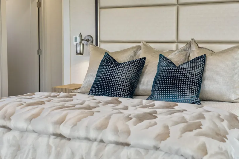 Shine Down Yacht Photos Pics Luxurious bedroom interior with plush pillows and elegant bedding on a Breaux Brothers 120 GLV yacht.