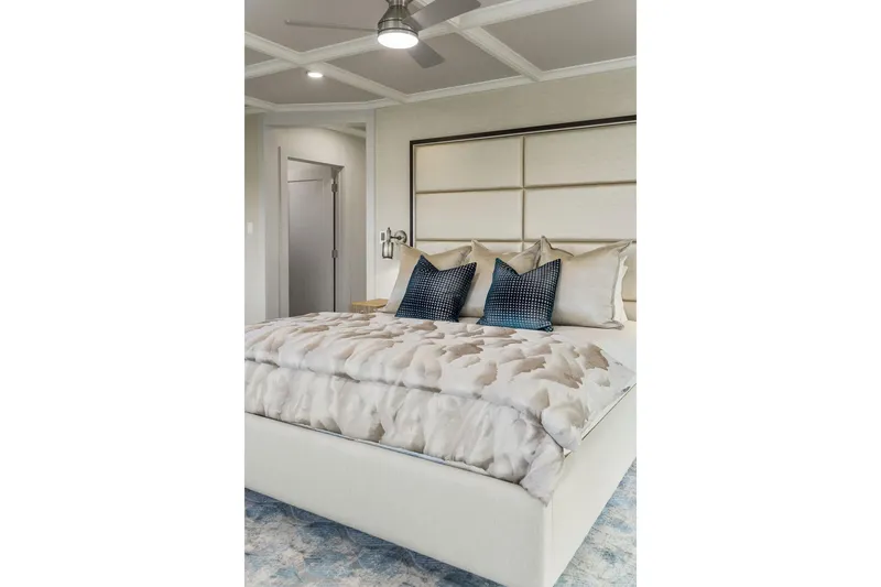 Shine Down Yacht Photos Pics Luxurious bedroom with modern decor, featuring plush bedding and stylish pillows, 2025 Breaux Brothers 120 GLV.