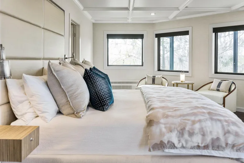 Shine Down Yacht Photos Pics Luxurious bedroom with elegant bedding, modern decor, and large windows in a Breaux Brothers 120 GLV.