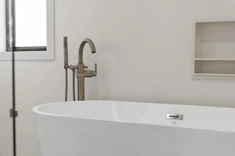 Shine Down Yacht Photos Pics Modern bathroom with sleek freestanding tub and elegant faucet, Breaux Brothers 120 GLV, 2025 model.