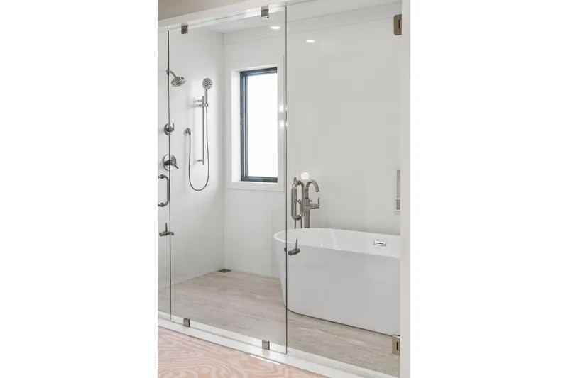 Shine Down Yacht Photos Pics Modern bathroom with glass shower, freestanding tub, and sleek fixtures, Breaux Brothers 120 GLV 2025.