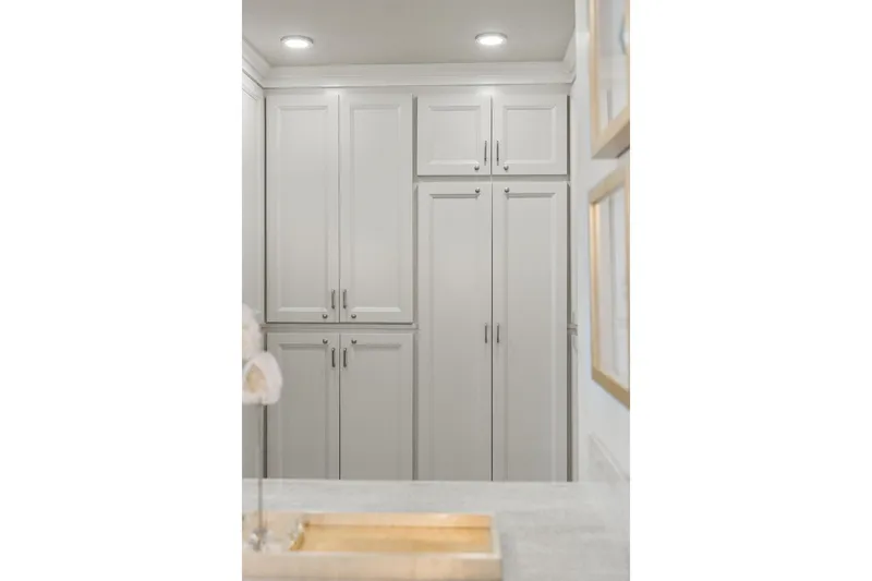 Shine Down Yacht Photos Pics Modern kitchen cabinetry with sleek white design, featuring recessed lighting and elegant decor.