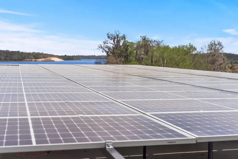 Shine Down Yacht Photos Pics Solar panels near a lake with trees, Breaux Brothers 120 GLV, 2025 model.