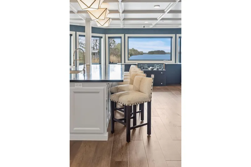 Shine Down Yacht Photos Pics Luxurious kitchen interior on Breaux Brothers 120 GLV yacht, featuring elegant bar stools and scenic views.