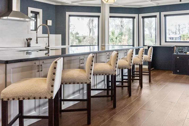 Shine Down Yacht Photos Pics Luxurious kitchen interior on Breaux Brothers 120 GLV yacht, featuring elegant bar stools and panoramic windows.