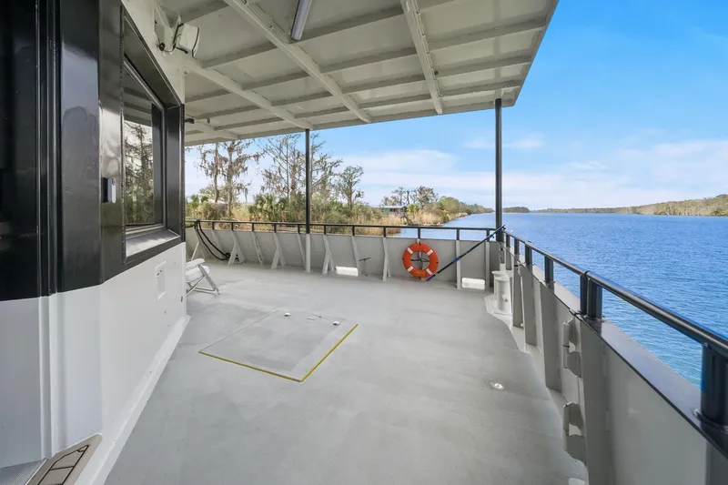 Shine Down Yacht Photos Pics Deck view of 2025 Breaux Brothers 120 GLV boat overlooking serene waterway.