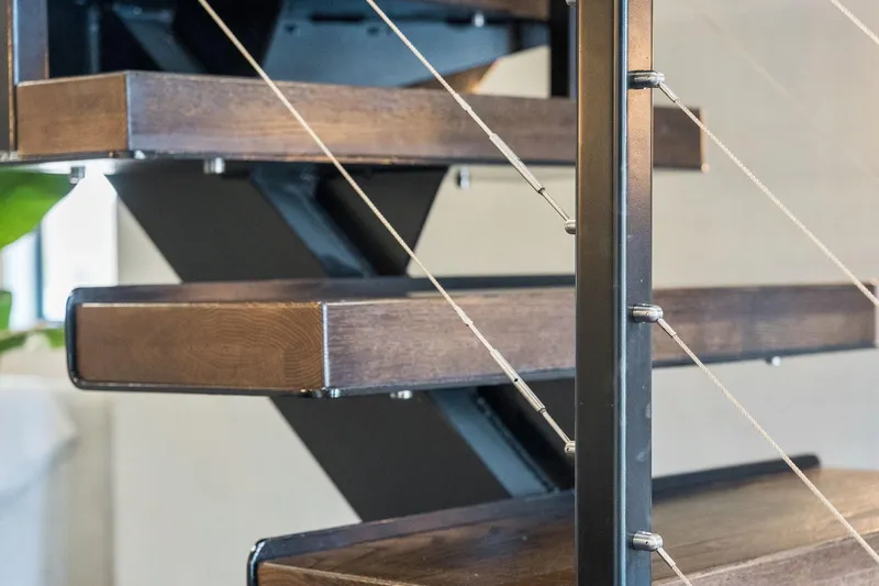 Shine Down Yacht Photos Pics Modern wooden staircase with metal railing, featuring sleek design elements. Breaux Brothers 120 GLV, 2025 model.