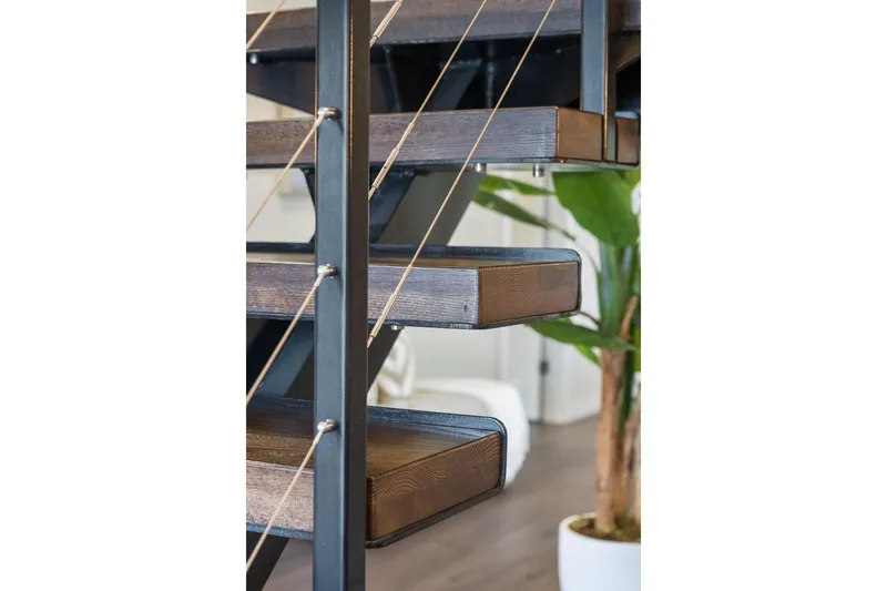 Shine Down Yacht Photos Pics Modern staircase with wooden steps and metal railing, featuring a potted plant in the background.