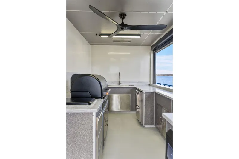 Shine Down Yacht Photos Pics Modern kitchen interior on Breaux Brothers 120 GLV yacht, 2025 model, with sleek appliances.