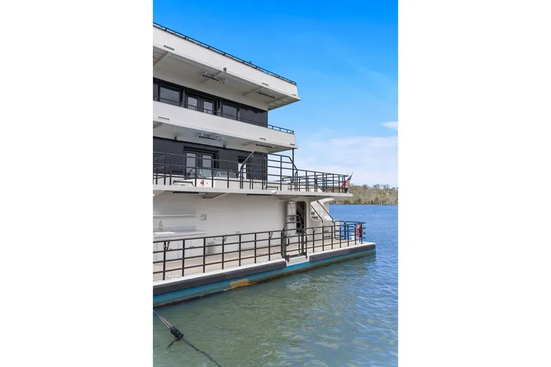 Shine Down Yacht Photos Pics Breaux Brothers 120 GLV boat, 2025 model, docked on calm water under clear blue sky.