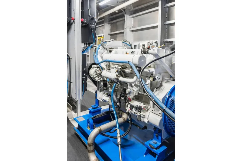 Shine Down Yacht Photos Pics Engine room of 2025 Breaux Brothers 120 GLV vessel, showcasing machinery and piping.