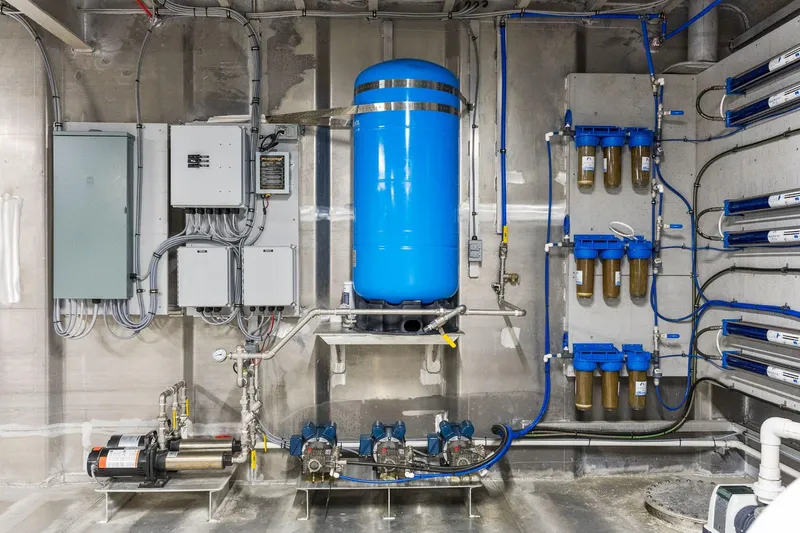 Shine Down Yacht Photos Pics Mechanical room with blue tank, filtration system, and electrical panels, Breaux Brothers 120 GLV, 2025 model.