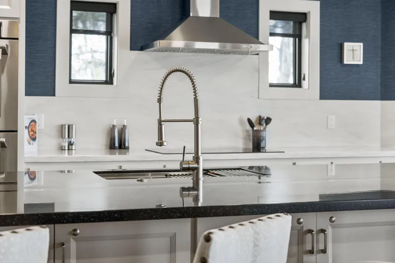 Shine Down Yacht Photos Pics Modern kitchen with sleek faucet, marble countertops, and stainless steel appliances.