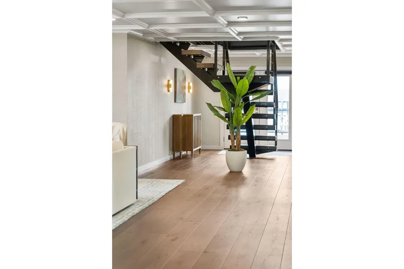 Shine Down Yacht Photos Pics Modern interior with spiral staircase, wooden flooring, and potted plant; Breaux Brothers 120 GLV 2025.