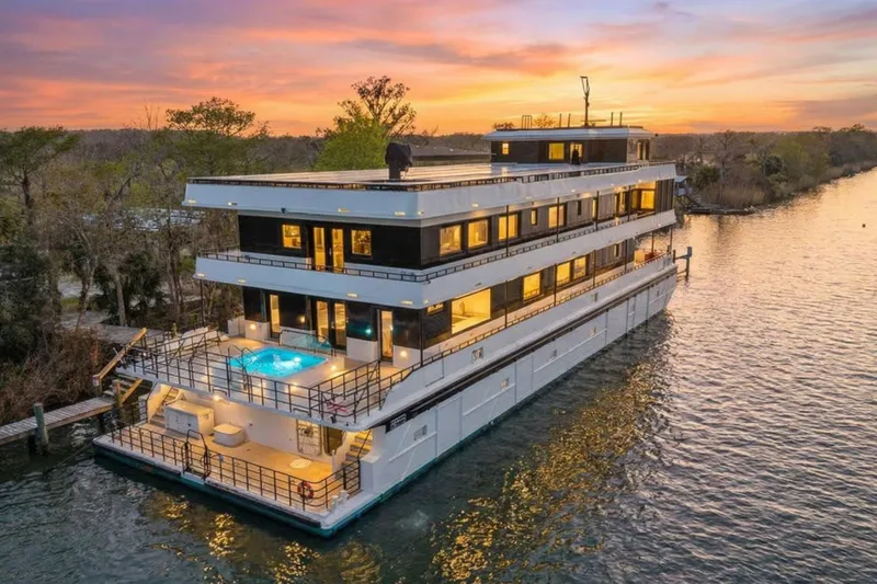 Shine Down Yacht Photos Pics Luxurious 2025 Breaux Brothers 120 GLV yacht with pool at sunset on a serene river.