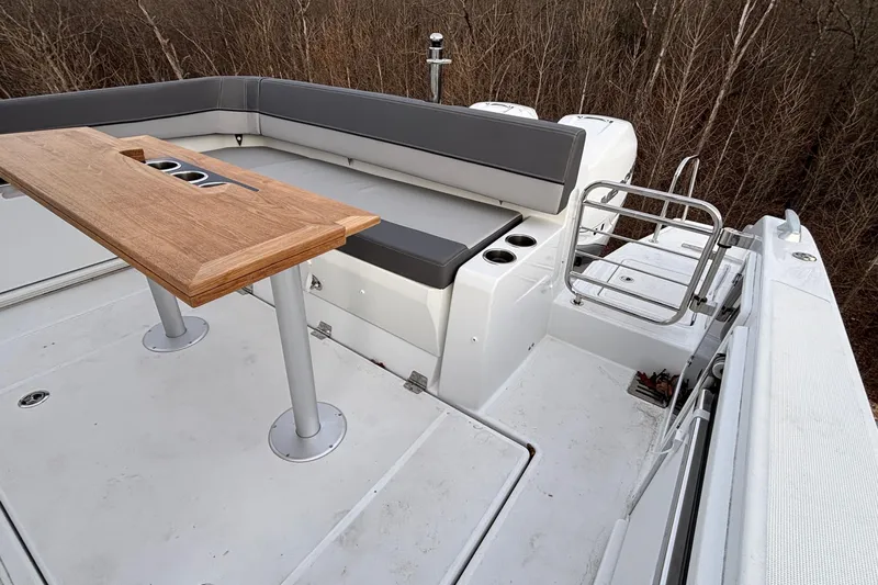  Yacht Photos Pics 2022 Jeanneau Leader 9.0 CC boat deck with seating and wooden table.