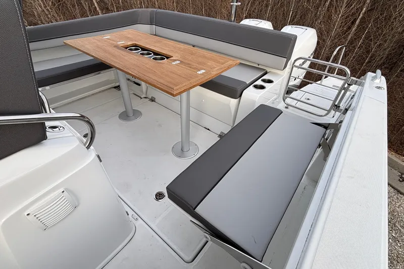  Yacht Photos Pics 2022 Jeanneau Leader 9.0 CC boat interior with seating and wooden table.
