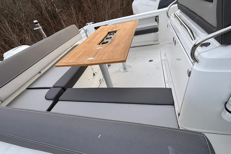  Yacht Photos Pics 2022 Jeanneau Leader 9.0 CC boat interior with seating and wooden table.