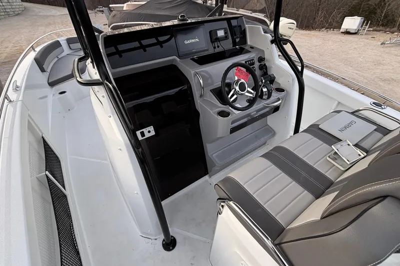  Yacht Photos Pics 2022 Jeanneau Leader 9.0 CC boat cockpit with steering wheel and Garmin navigation system.