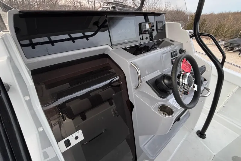  Yacht Photos Pics 2022 Jeanneau Leader 9.0 CC boat cockpit with steering wheel and navigation system.