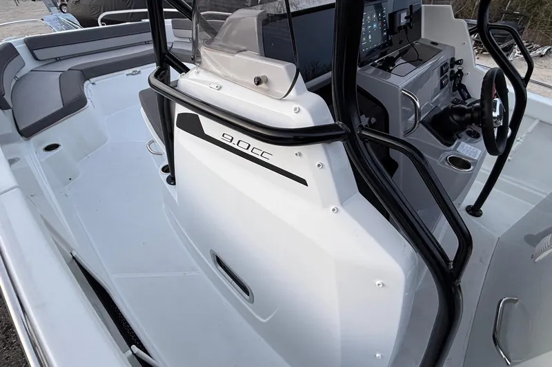  Yacht Photos Pics 2022 Jeanneau Leader 9.0 CC boat interior with steering console and seating area.