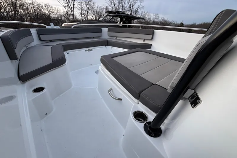  Yacht Photos Pics 2022 Jeanneau Leader 9.0 CC boat interior with gray seating and cup holders.