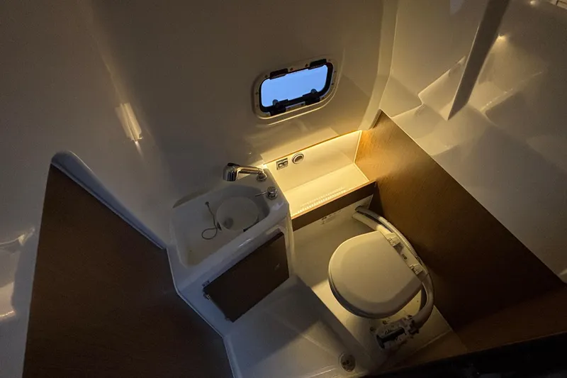  Yacht Photos Pics 2022 Jeanneau Leader 9.0 CC boat bathroom with sink, toilet, and window.