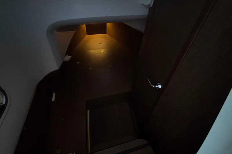 Yacht Photos Pics Dimly lit interior cabin of 2022 Jeanneau Leader 9.0 CC boat.