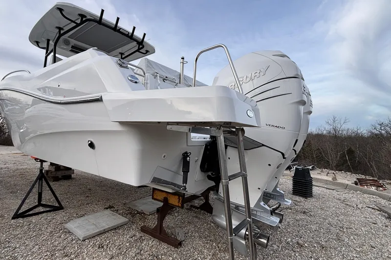  Yacht Photos Pics 2022 Jeanneau Leader 9.0 CC boat with Mercury Verado engine on a gravel surface.