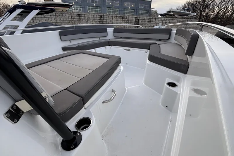  Yacht Photos Pics 2022 Jeanneau Leader 9.0 CC boat interior with cushioned seating and cup holders.