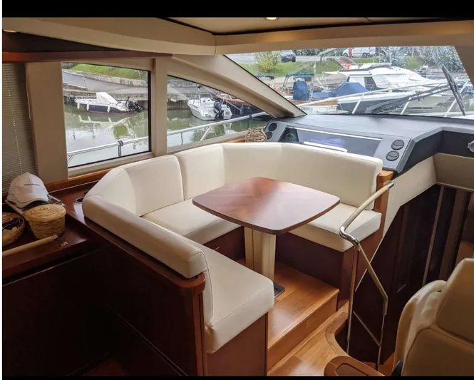  Yacht Photos Pics Luxurious interior of 2008 Princess V65 yacht with elegant seating and wooden table.