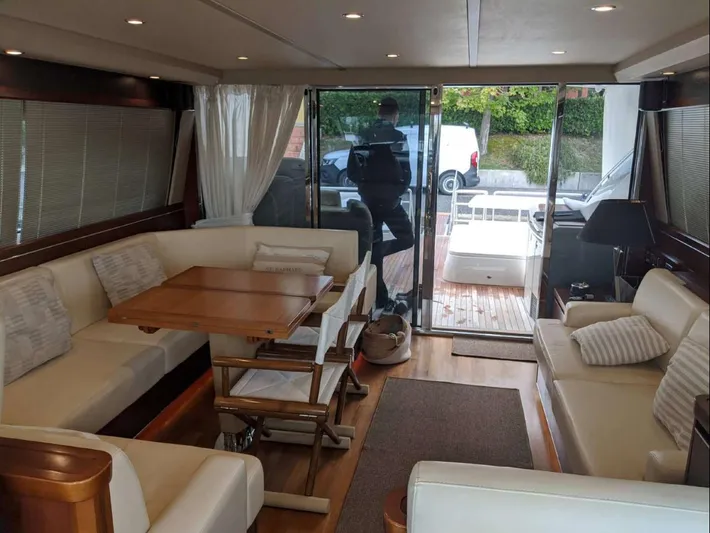  Yacht Photos Pics Luxurious interior of 2008 Princess V65 yacht with elegant seating and wooden table.