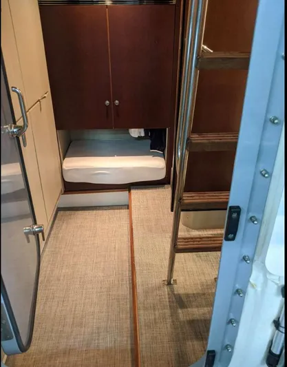  Yacht Photos Pics Interior of 2008 Princess V65 yacht with wooden cabinets and ladder.