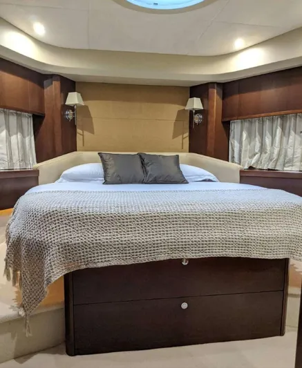  Yacht Photos Pics Luxurious bedroom interior of 2008 Princess V65 yacht with elegant bedding and ambient lighting.