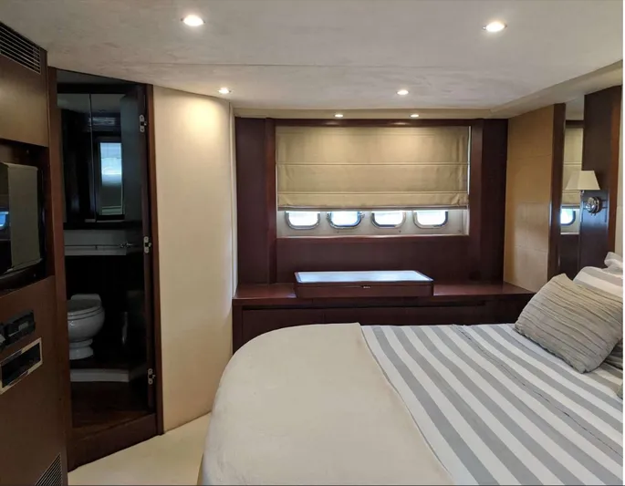  Yacht Photos Pics Luxurious bedroom interior of 2008 Princess V65 yacht with elegant furnishings and ambient lighting.