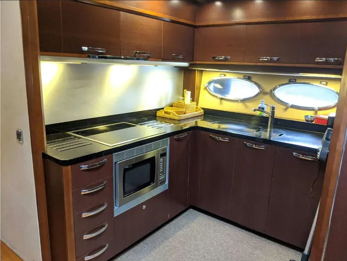  Yacht Photos Pics Luxurious kitchen interior of 2008 Princess V65 yacht with modern appliances and sleek cabinetry.