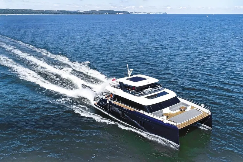  Yacht Photos Pics Luxurious 2020 Sunreef 80 Power yacht cruising on open sea.