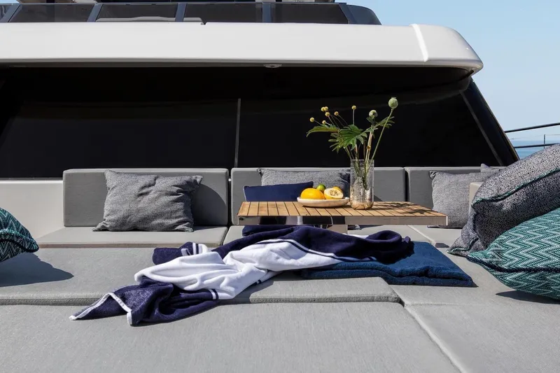  Yacht Photos Pics Luxurious Sunreef 80 Power yacht deck with cushions, table, and tropical decor, 2020 model.