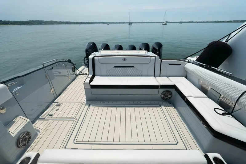  Yacht Photos Pics Luxurious 2025 Cigarette 52' Thunder yacht deck with sleek seating and powerful engines.