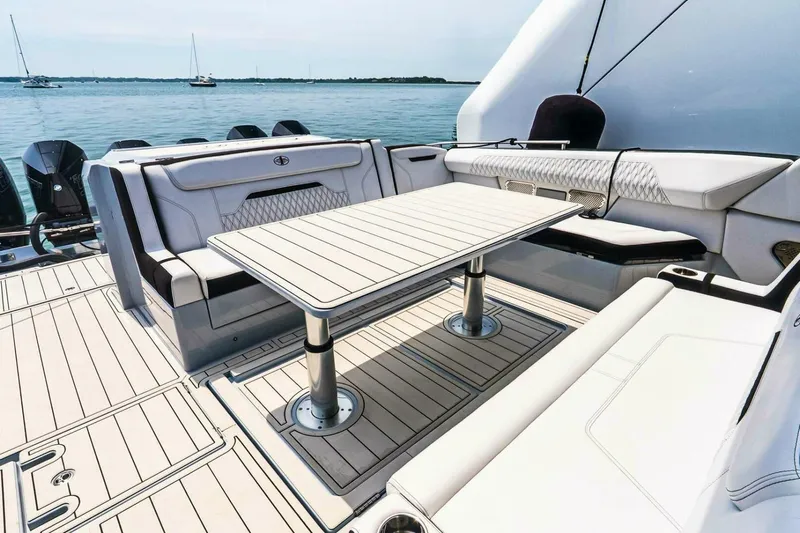  Yacht Photos Pics Luxurious seating area on 2025 Cigarette 52' Thunder yacht with elegant table design.