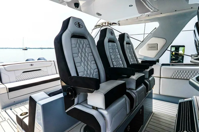  Yacht Photos Pics Luxury seating on 2025 Cigarette 52' Thunder boat, featuring sleek design and premium materials.