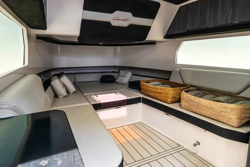  Yacht Photos Pics Luxurious interior of 2025 Cigarette 52' Thunder boat with seating and storage baskets.
