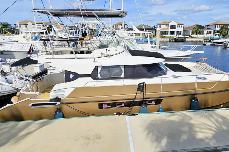 Worth The Wait Yacht Photos Pics 1999 Fountaine Pajot Maryland 37 yacht docked at marina with clear skies.