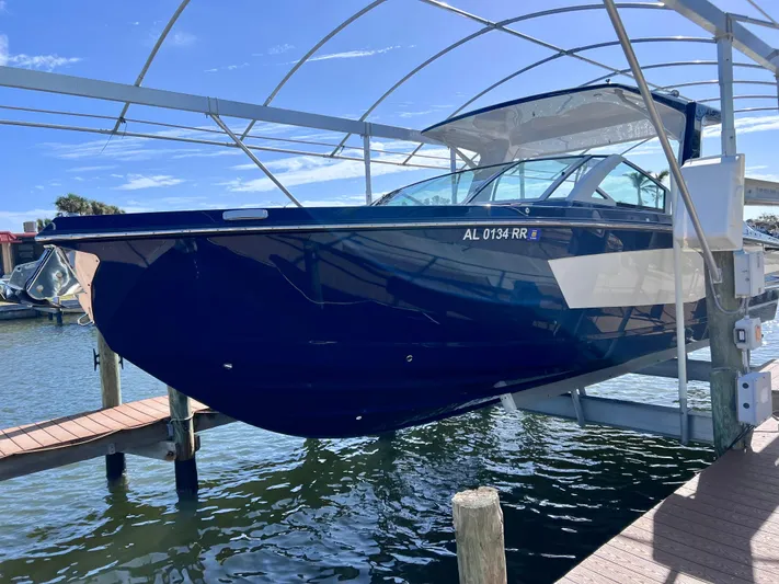 Impulse Yacht Photos Pics 2022 Aviara AV 32 Outboard boat docked on a lift in a marina.