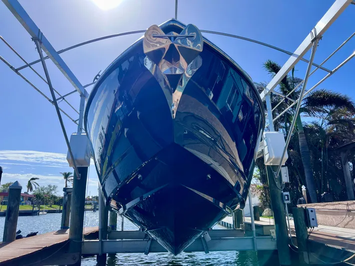 Impulse Yacht Photos Pics 2022 Aviara AV 32 Outboard boat on lift under clear blue sky.